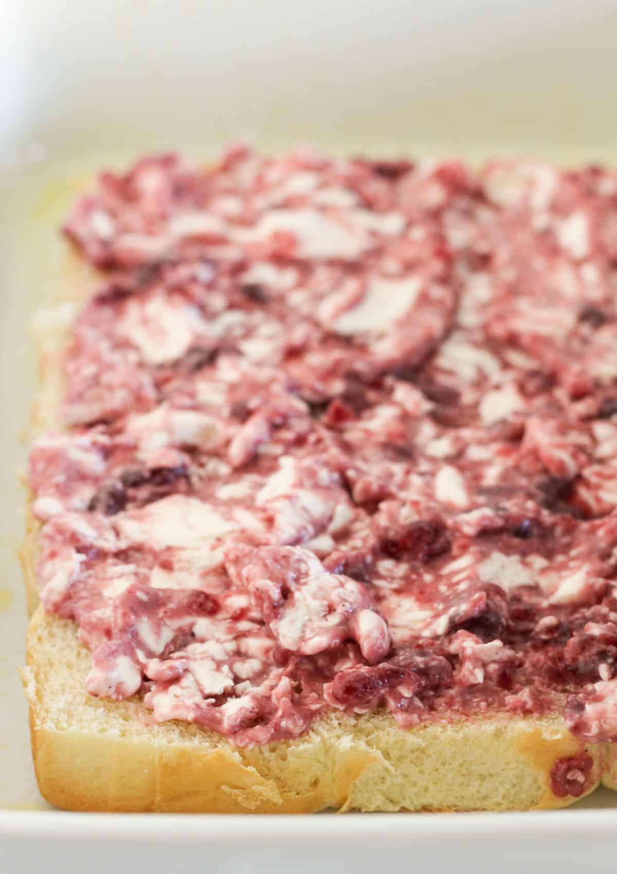 Adding the cranberry cream cheese mixture to rolls.