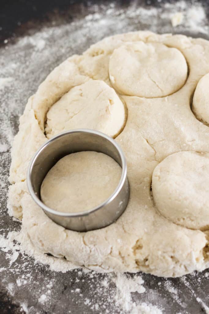Rolling the sweet biscuit dough out and cut into biscuits.