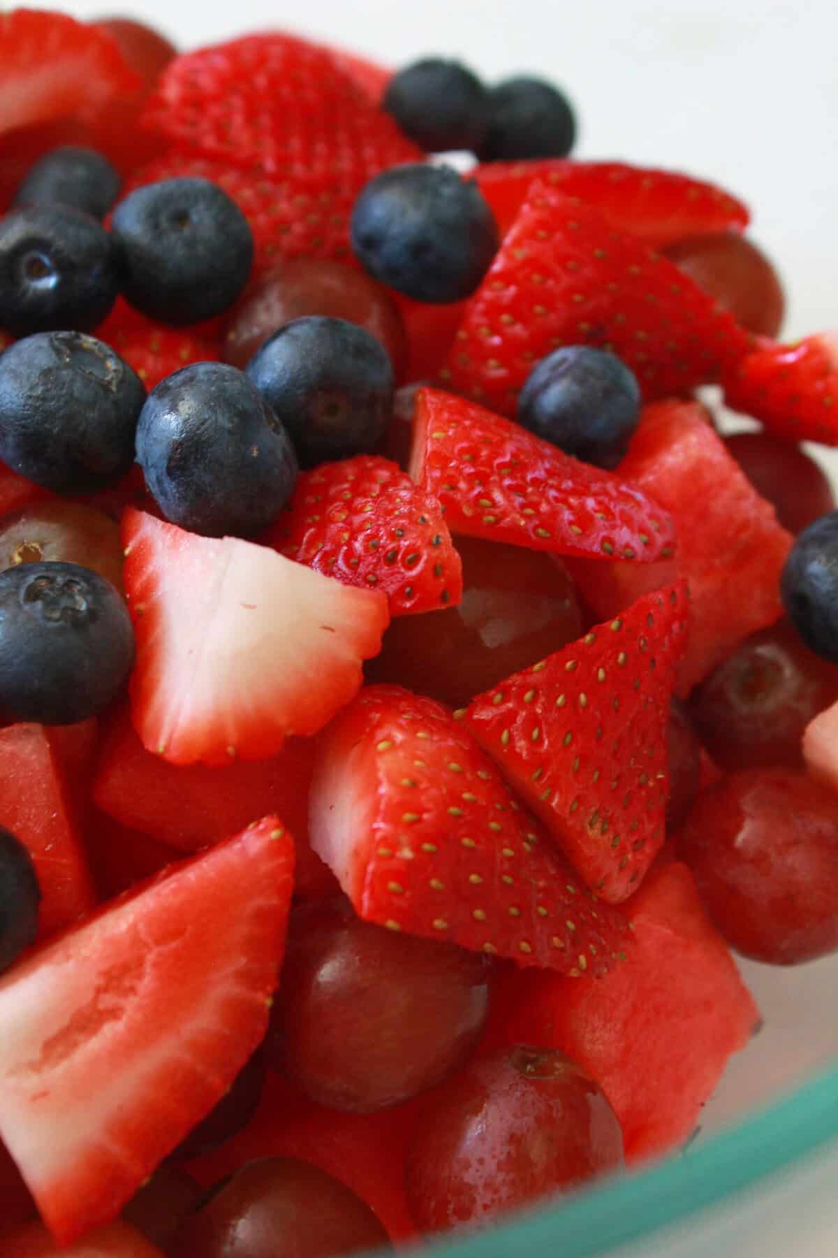 Fresh fruit in a bowl for a red white and blue fruit salad.