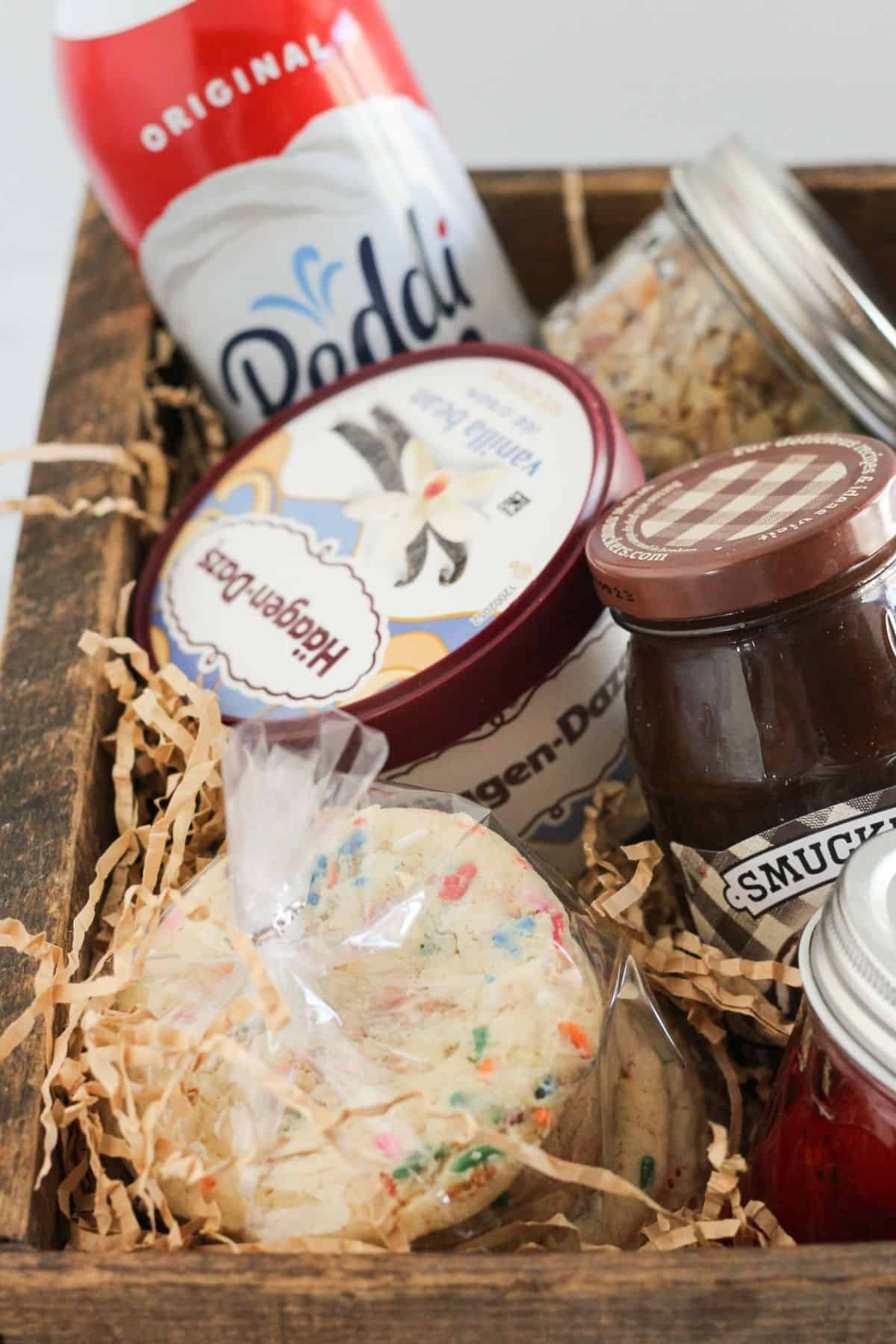 Cookies and toppings in a basket for a gift.