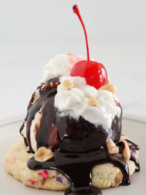 An ice cream sundae cookie topped with ice cream and toppings.