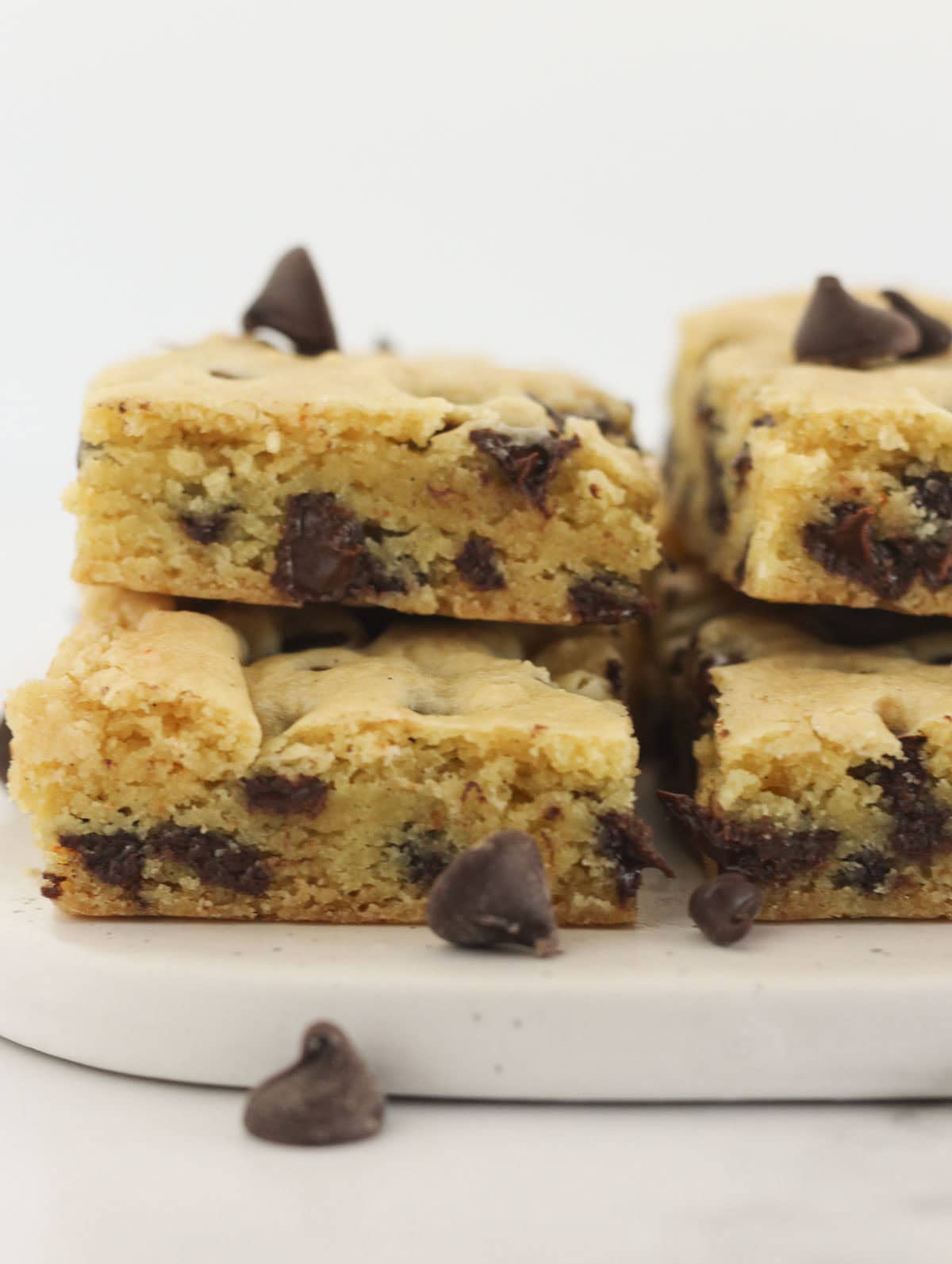 Stacks of chocolate chip cookie bars made with a yellow cake mix.
