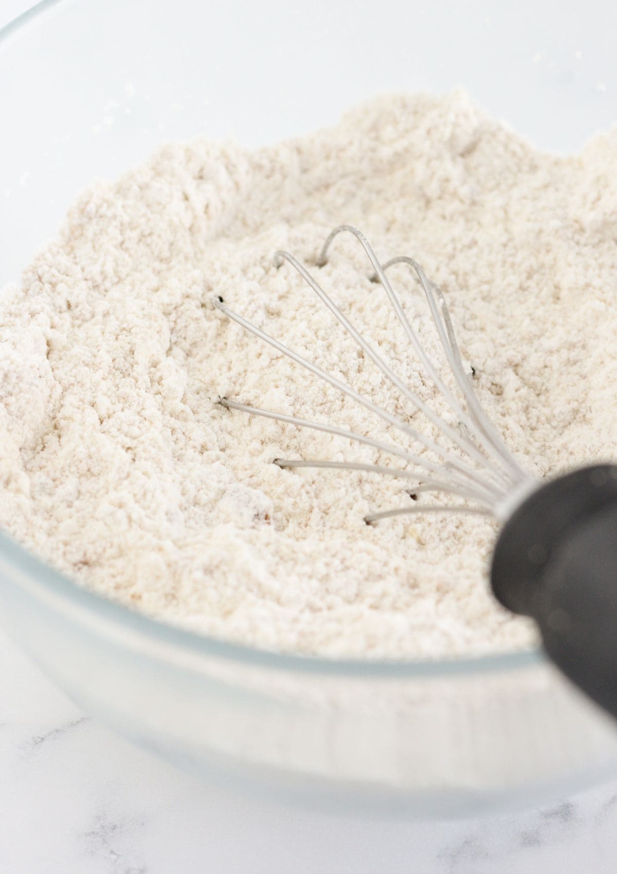 Whisking the dry ingredients in a bowl.