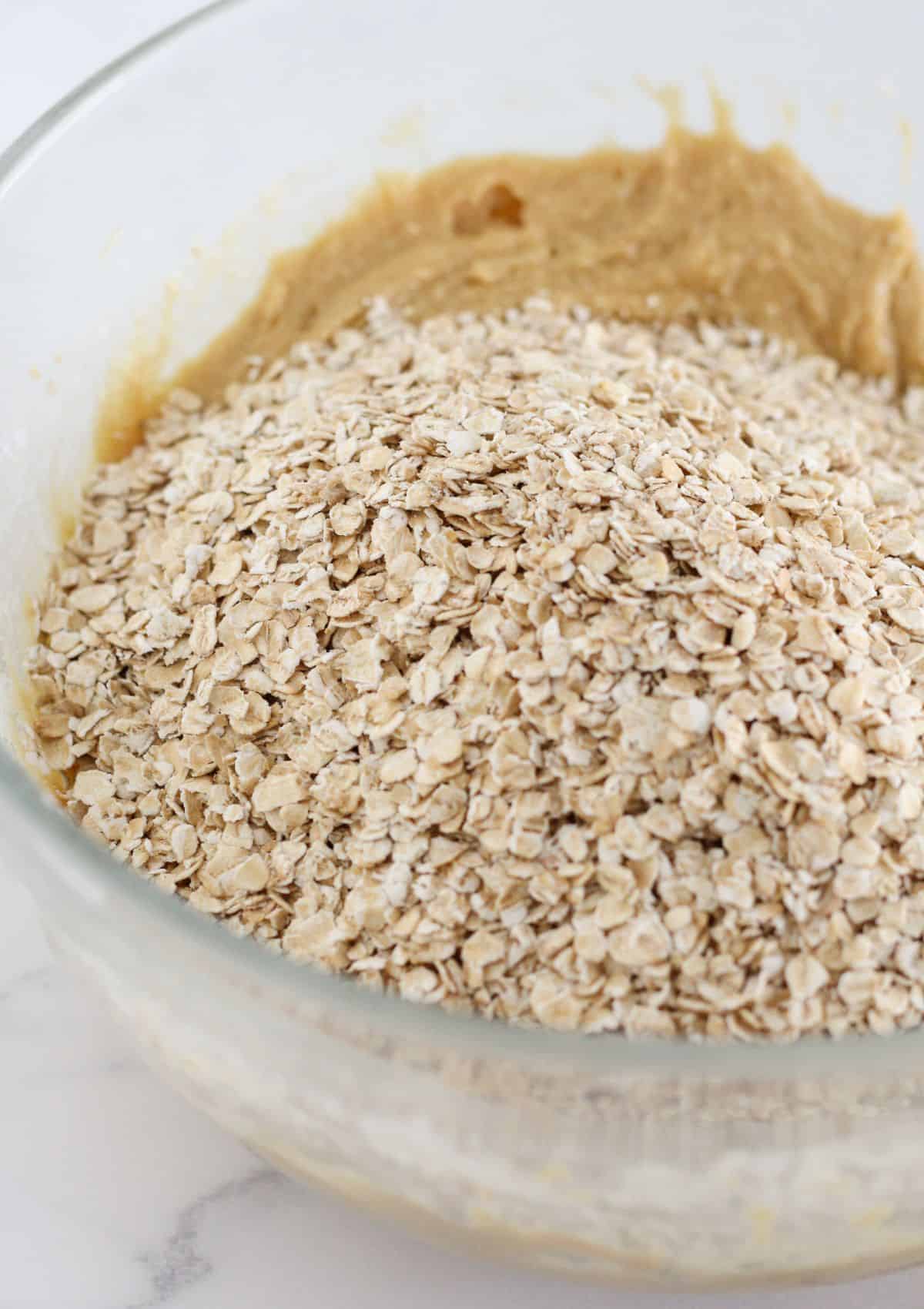 Adding oats to the cookie dough.