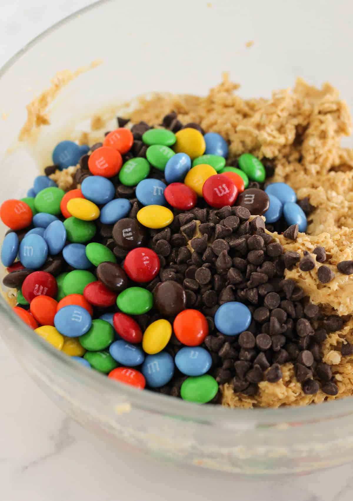 Adding the chocolate chips and candies to the cookie dough.