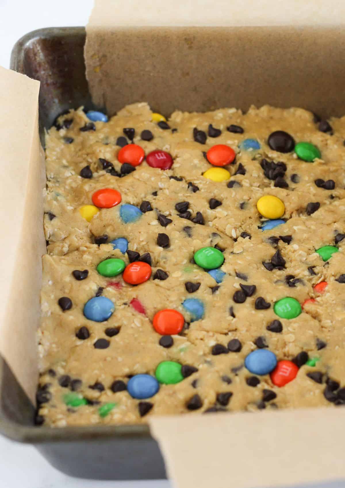 Adding the cookie dough to the prepared pan.