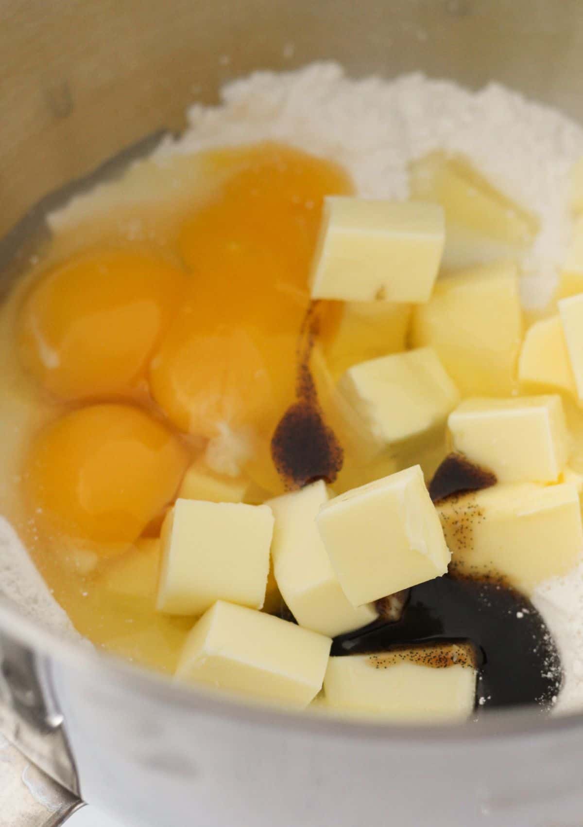 Adding the eggs, butter, shortening and vanilla to the cake mix.