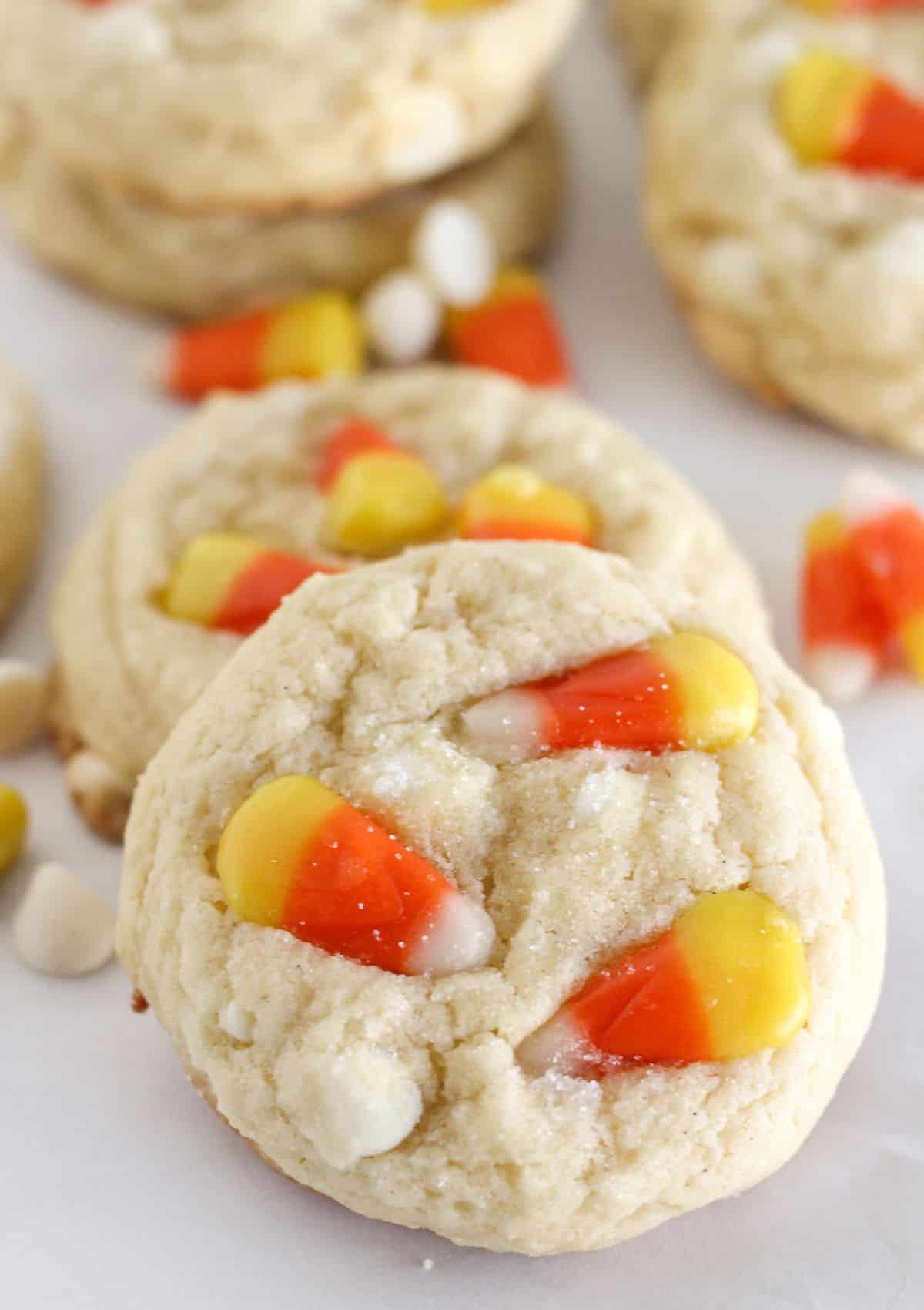 Candy corn cookies on a white tray.