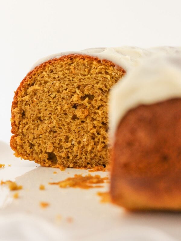 A pumpkin spice bundt cake with slices removed.