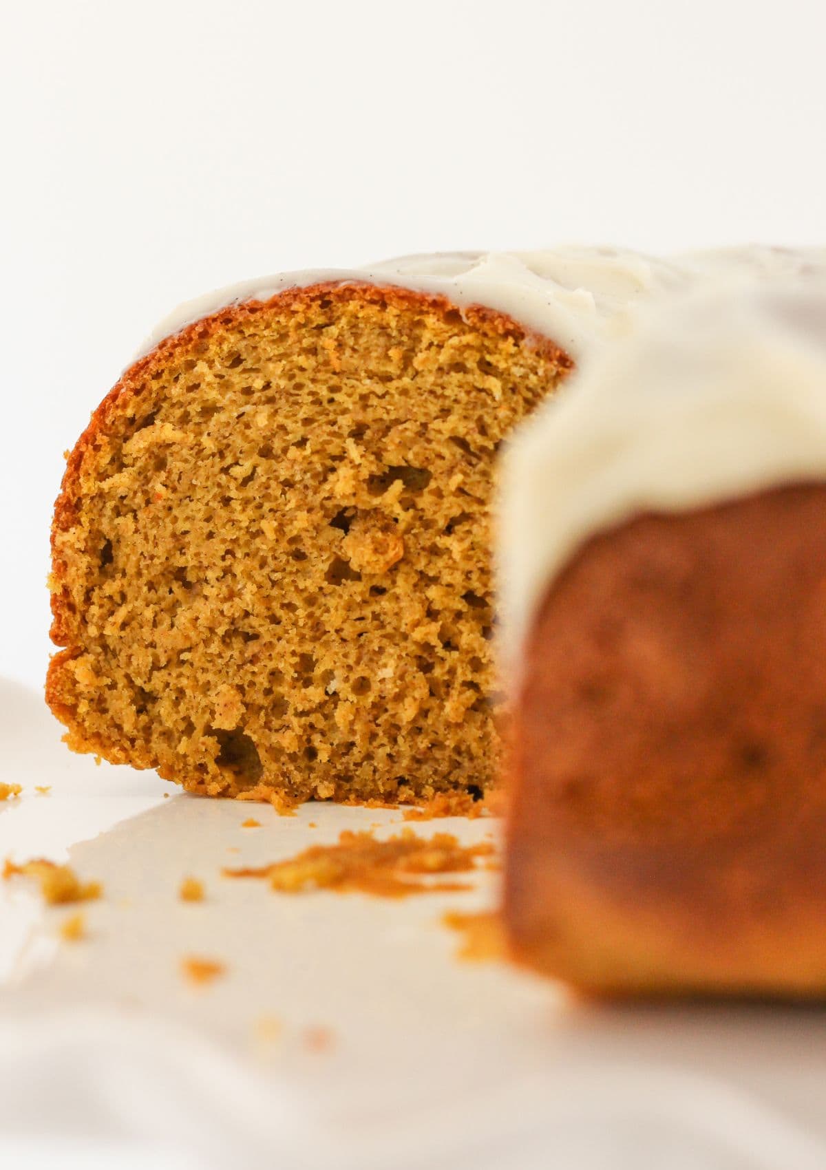 A pumpkin spice bundt cake with slices removed.