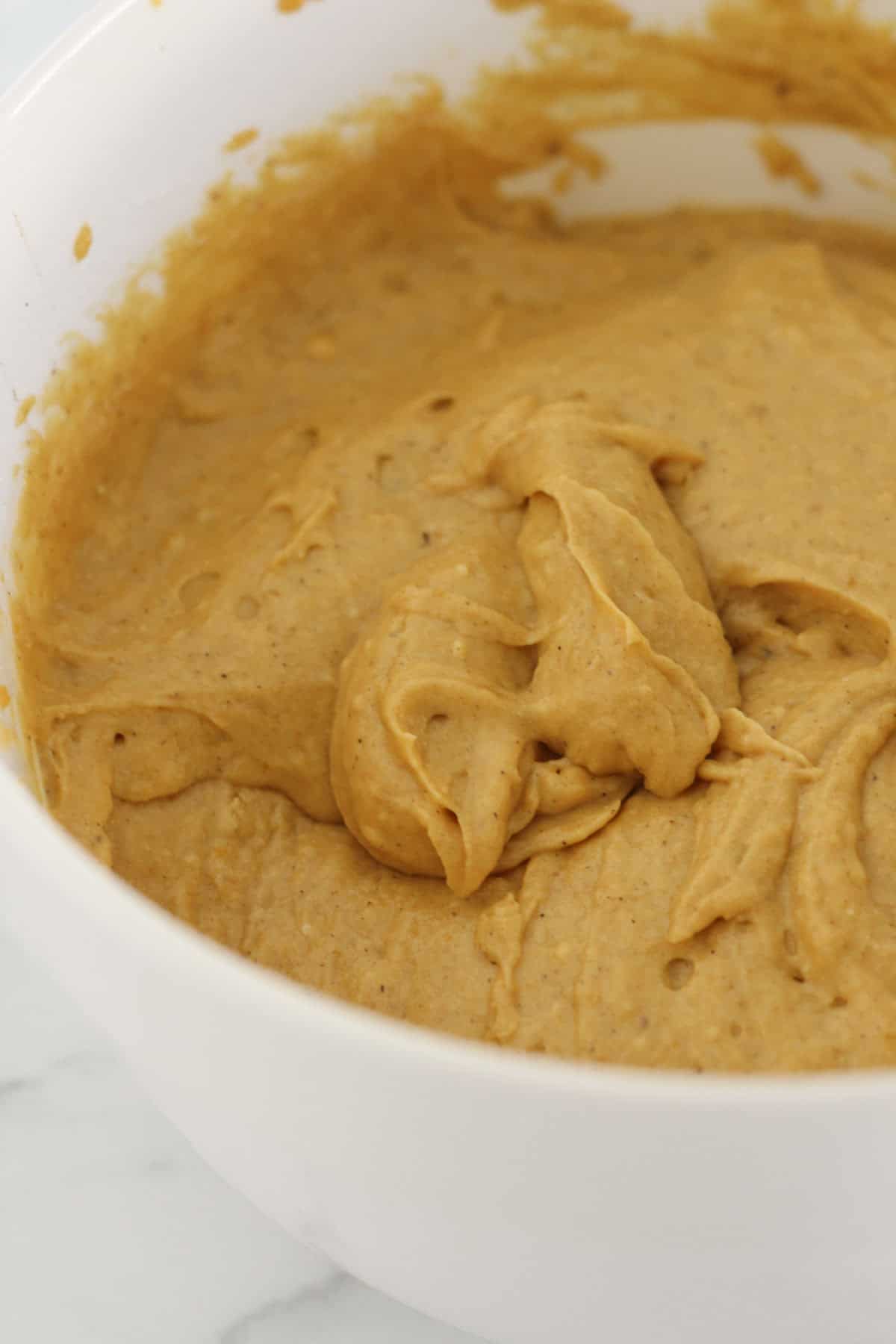 Adding the wet ingredients to dry ingredients and mixing batter.