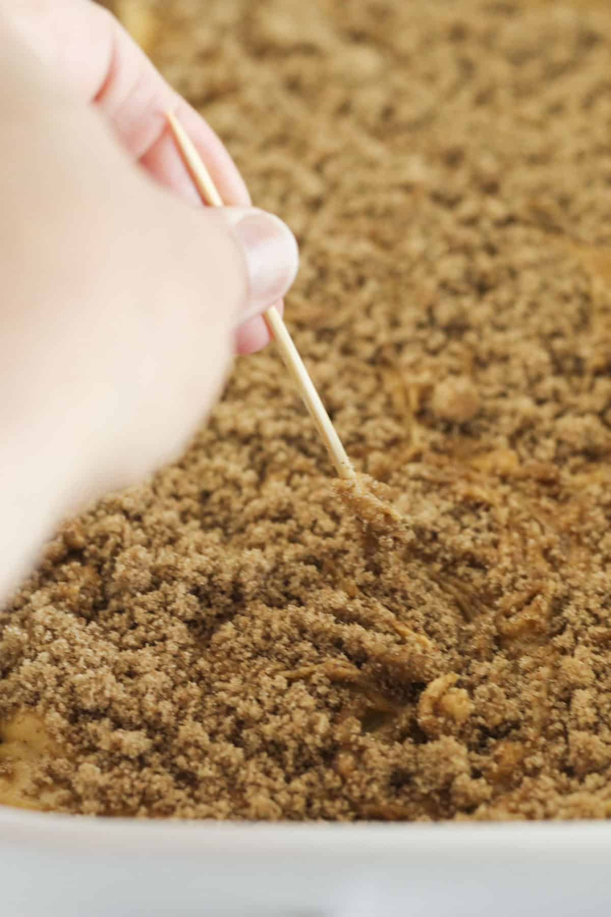 Adding the other half of cinnamons swirl mixture and swirling it into the cake.