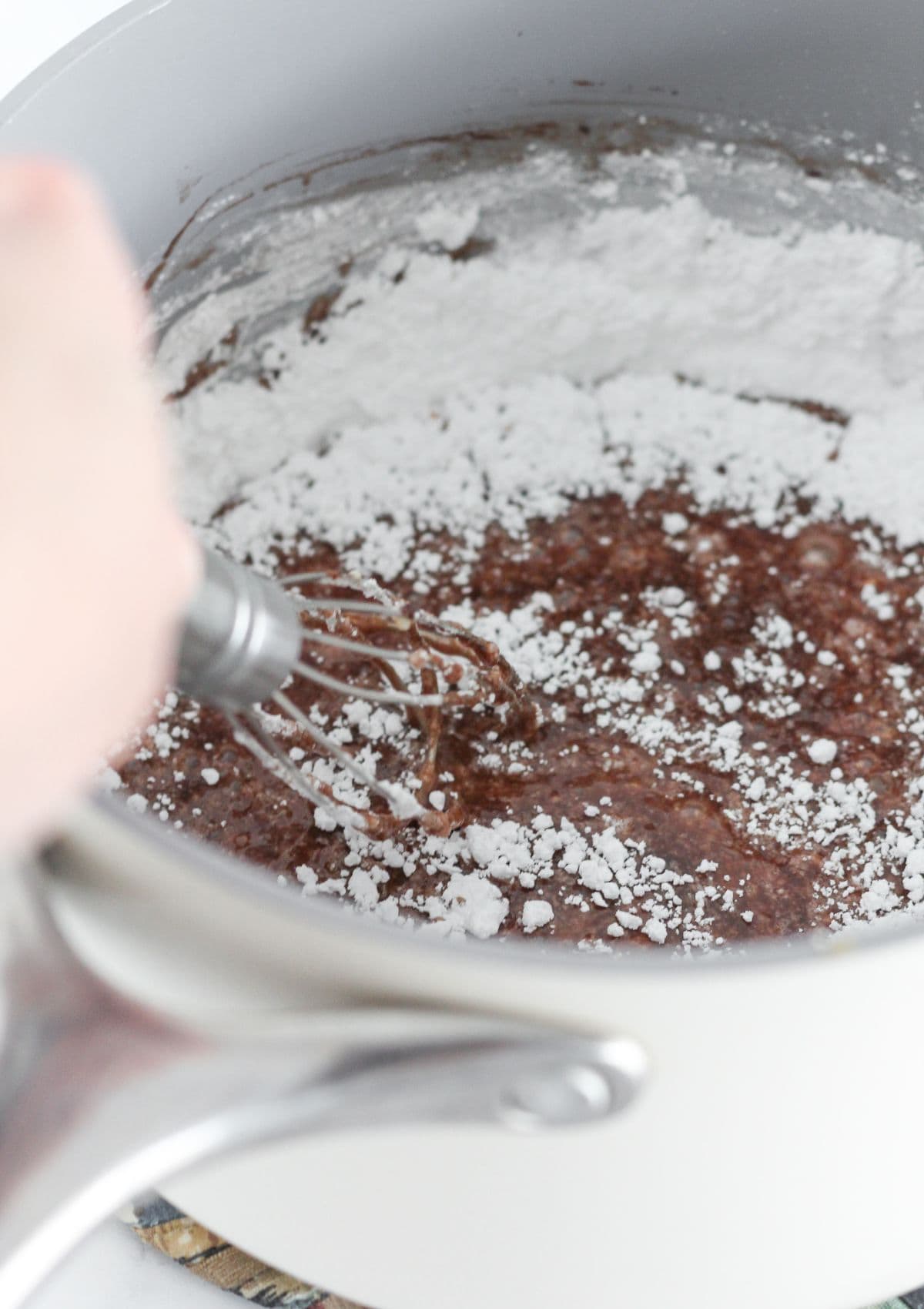 Making the chocolate frosting in a sauce pan.
