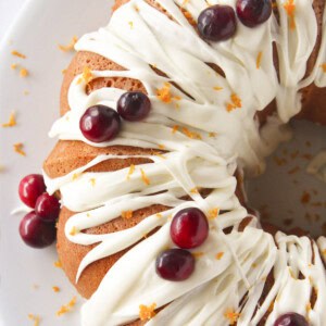 Looking at the top of a cranberry orange bundt cake with frosting.