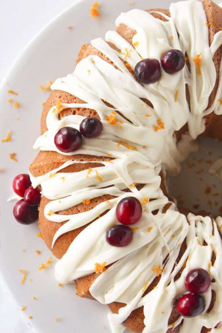 Looking at the top of a cranberry orange bundt cake with frosting.