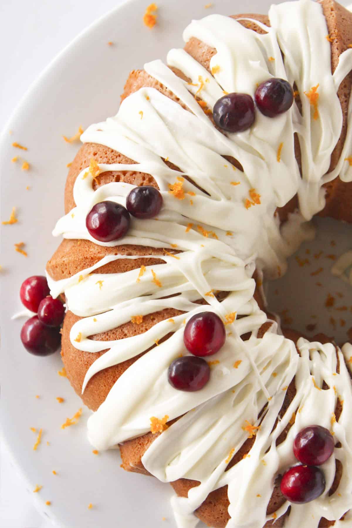 Looking at the top of a cranberry orange bundt cake with frosting.