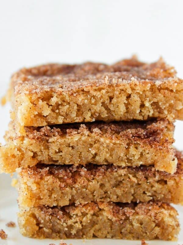 Four Churro Bars with cinnamon sugar topping stacked on each other.