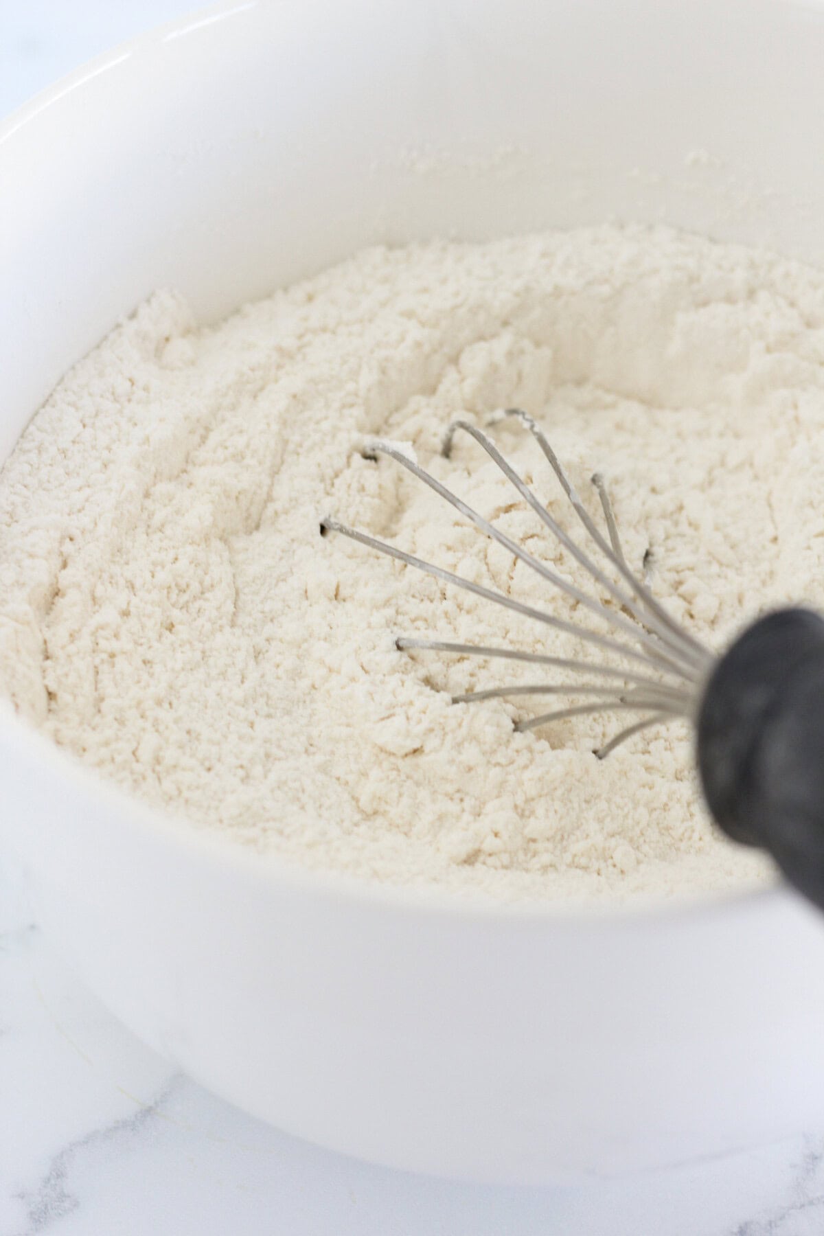 Sifting the dry ingredients together for the lemon poppy seed cookies.