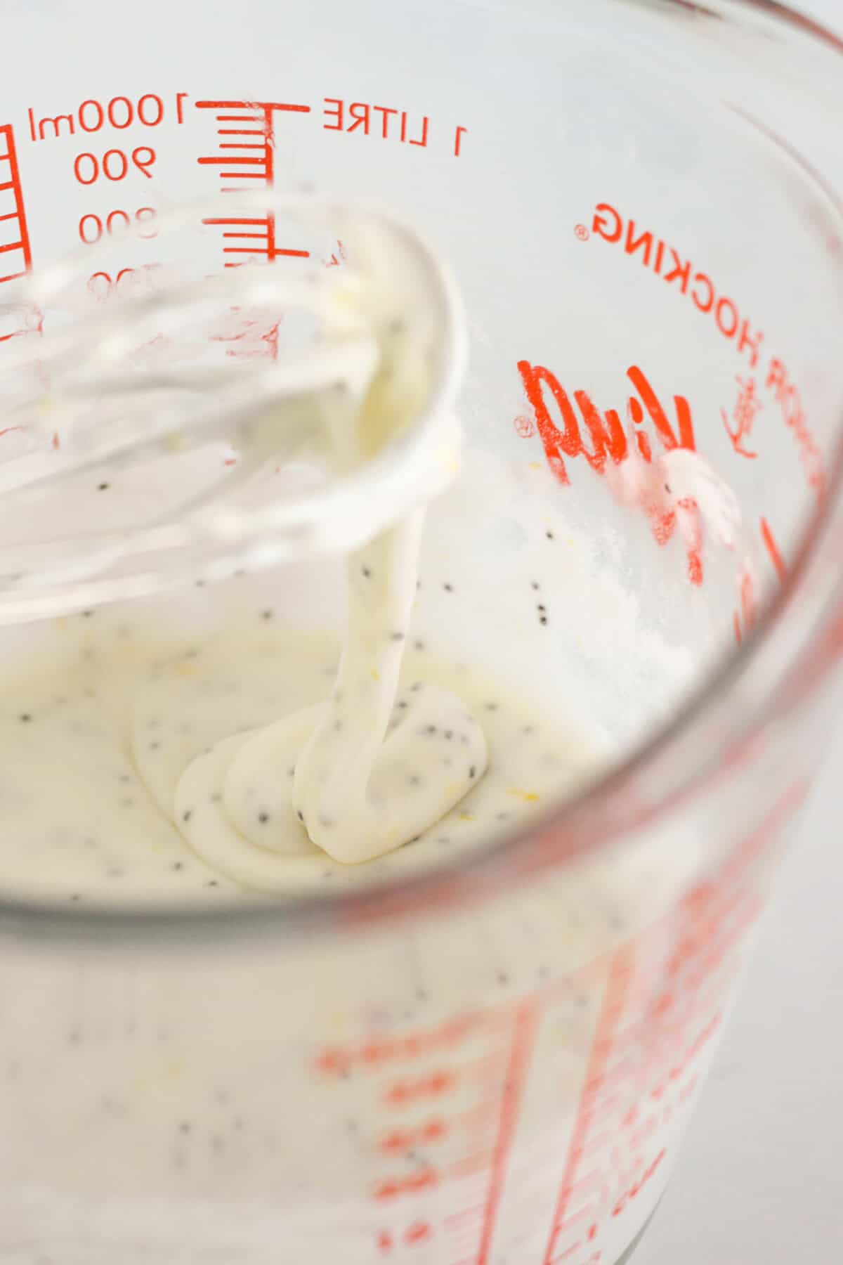 Whisking the lemon glaze for the poppy seed cookies.