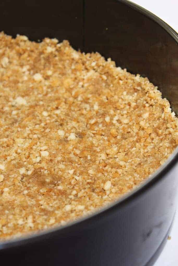 A vanilla wafer crust in a springform pan.