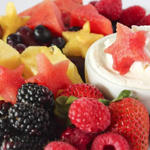 A 4th of July fruit platter with cheesecake dip.