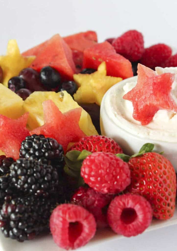 A 4th of July fruit platter with cheesecake dip.