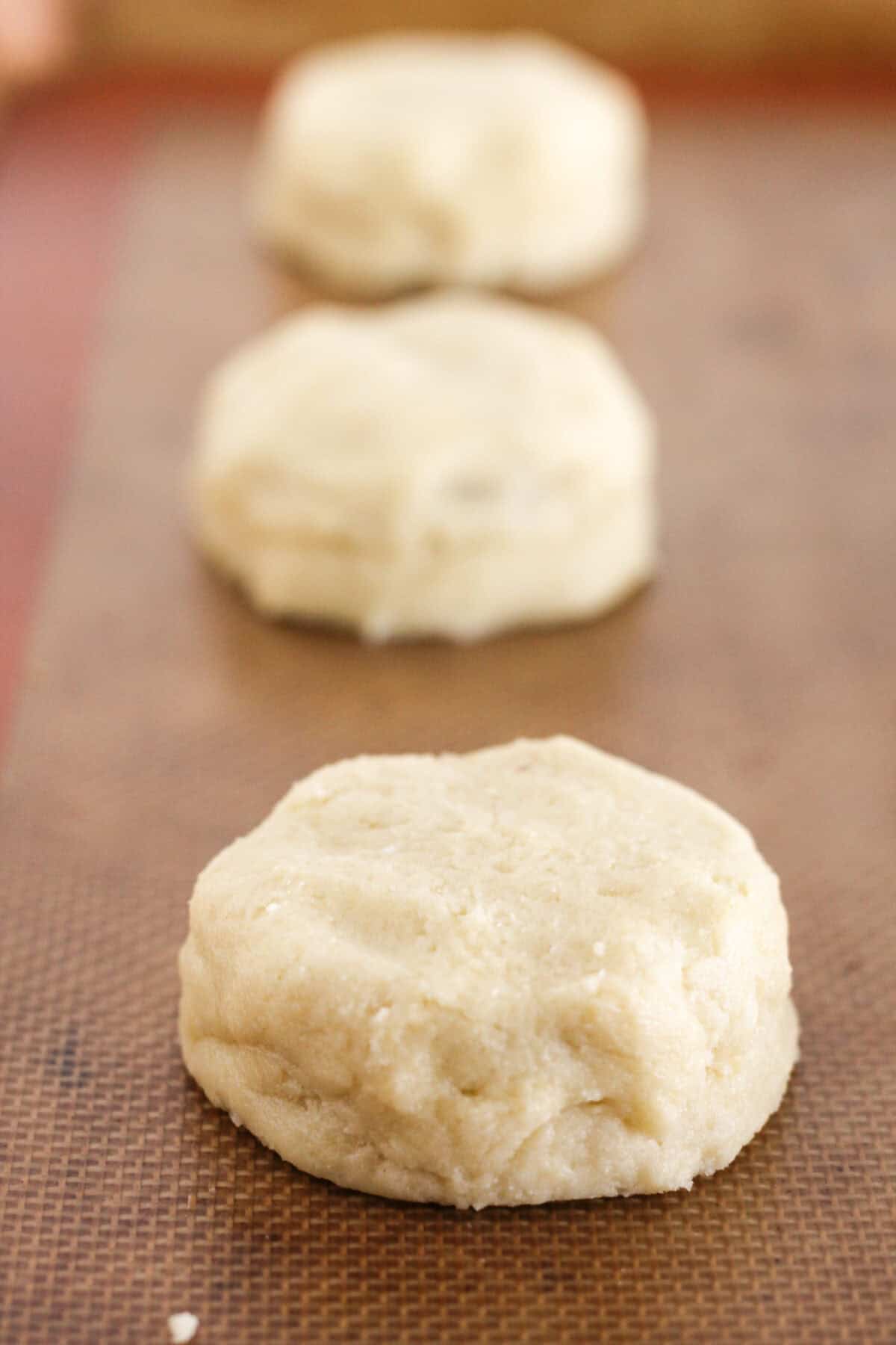 Topping the peanut butter cup with more cookie dough.