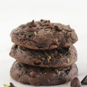 Three chocolate cake mix zucchini cookies stacked on each other.