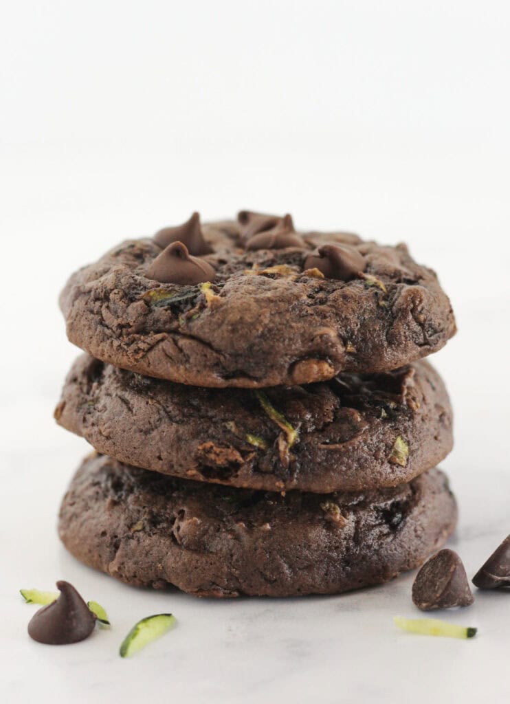 Three chocolate cake mix zucchini cookies stacked on each other.