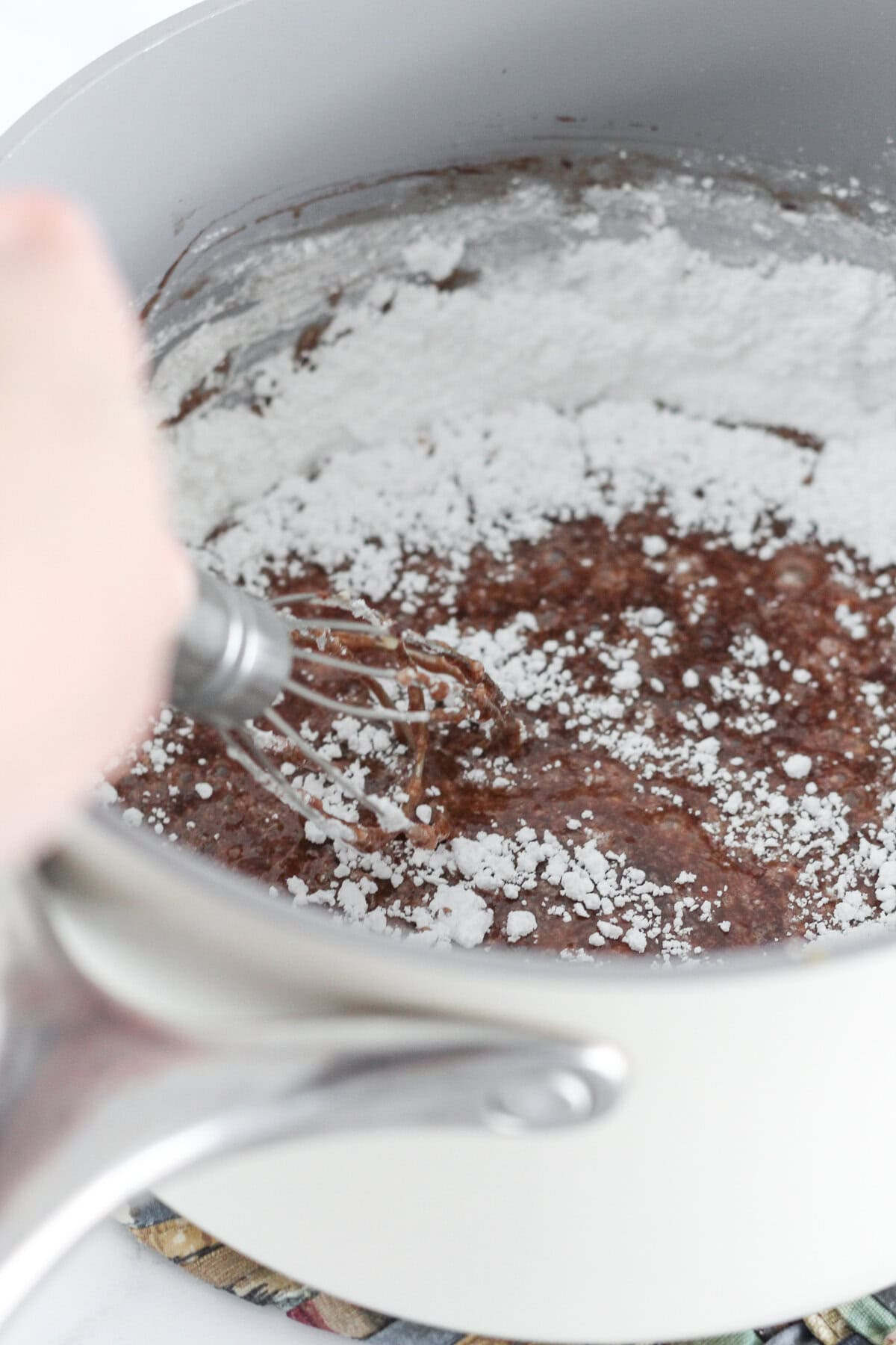 Making the sheet cake frosting in a saucepan.