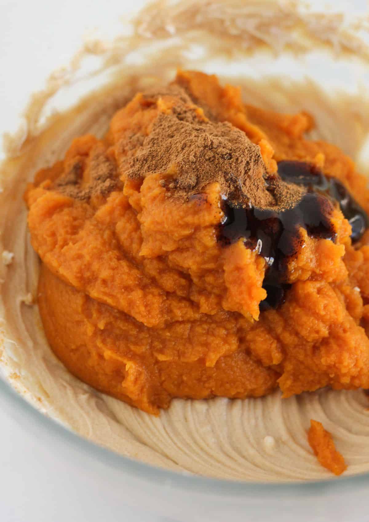 Adding the pumpkin and spice to the mousse filling.