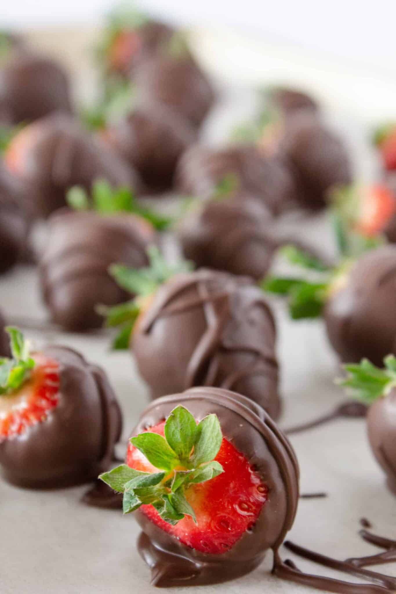 Dipping the strawberries in melted chocolate.