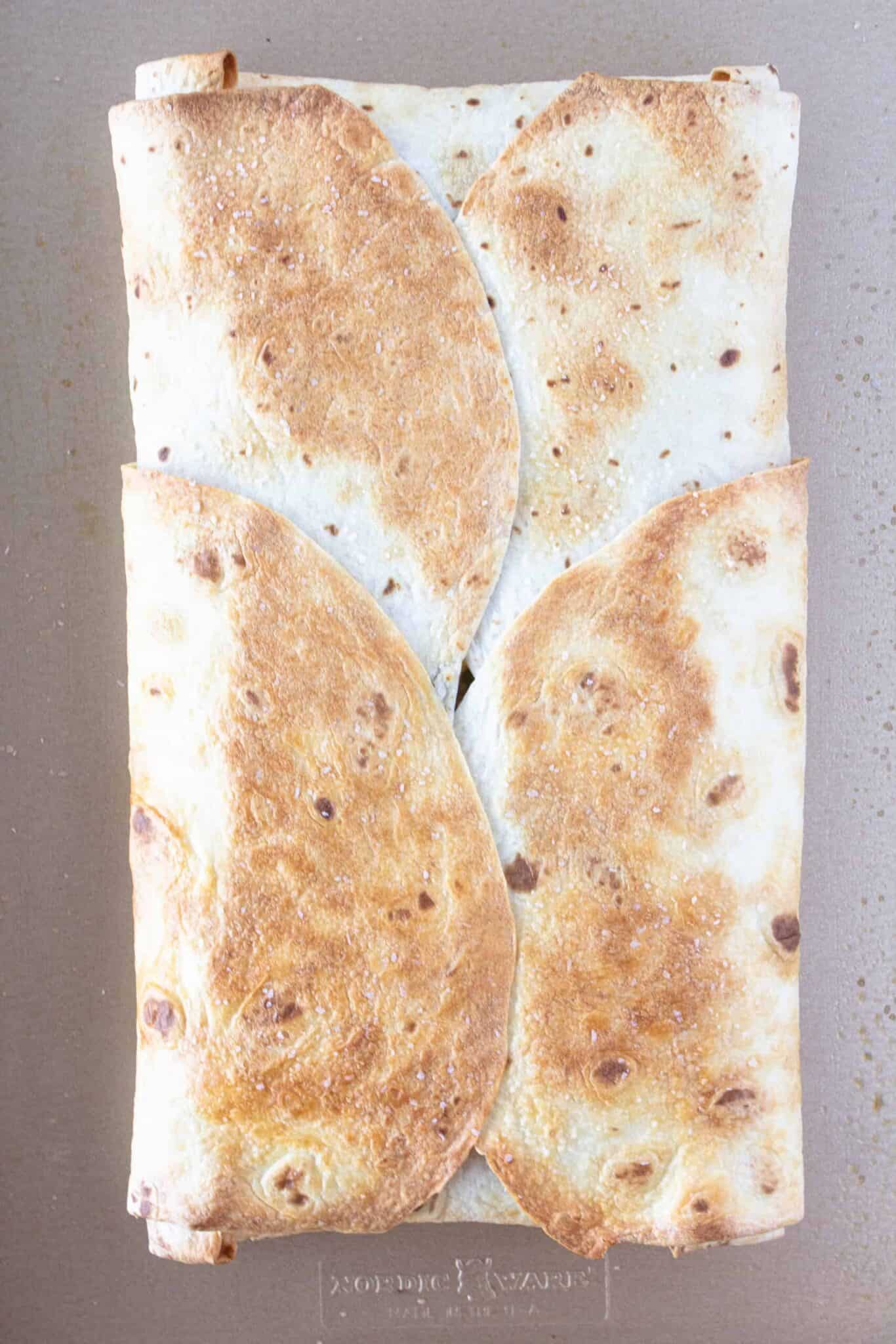 A baked Breakfast Quesadilla on a sheet pan.