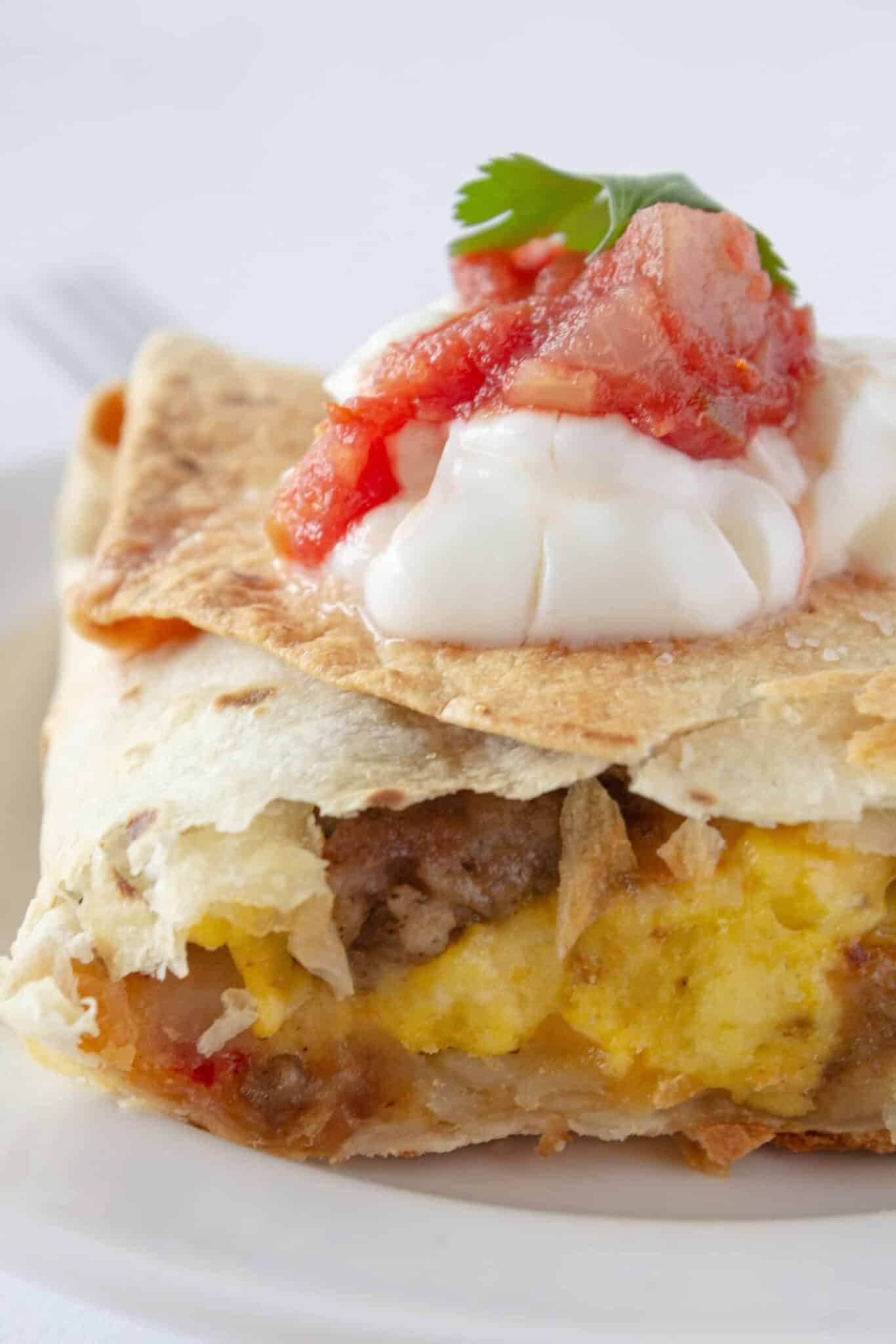 Sheet Pan Breakfast Quesadilla serving on a plate with toppings.