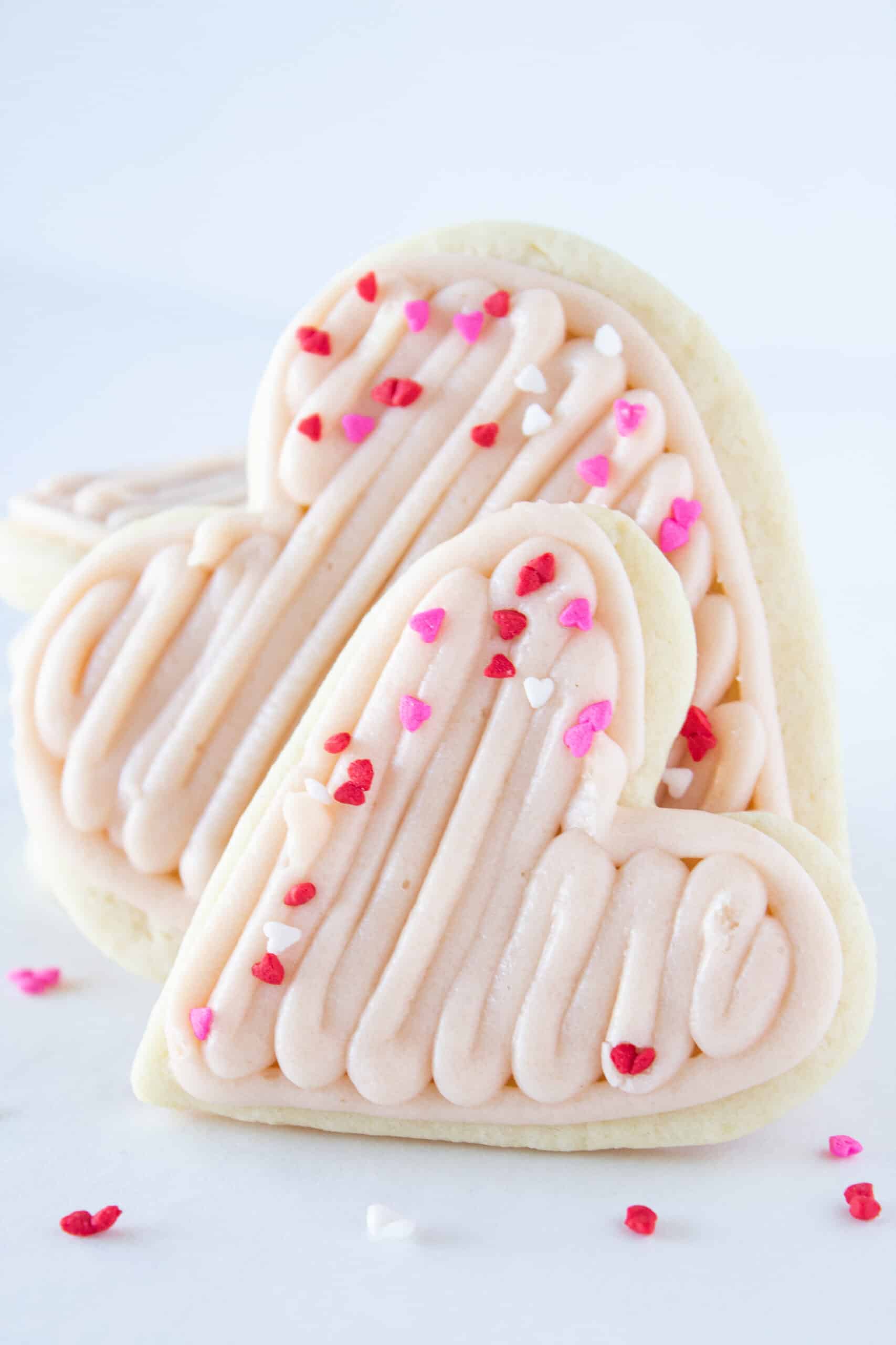 Easy Valentine Heart Shaped Sugar Cookies Recipe with Easy Strawberry Buttercream Frosting featured by top US cookie blogger, Practically Homemade