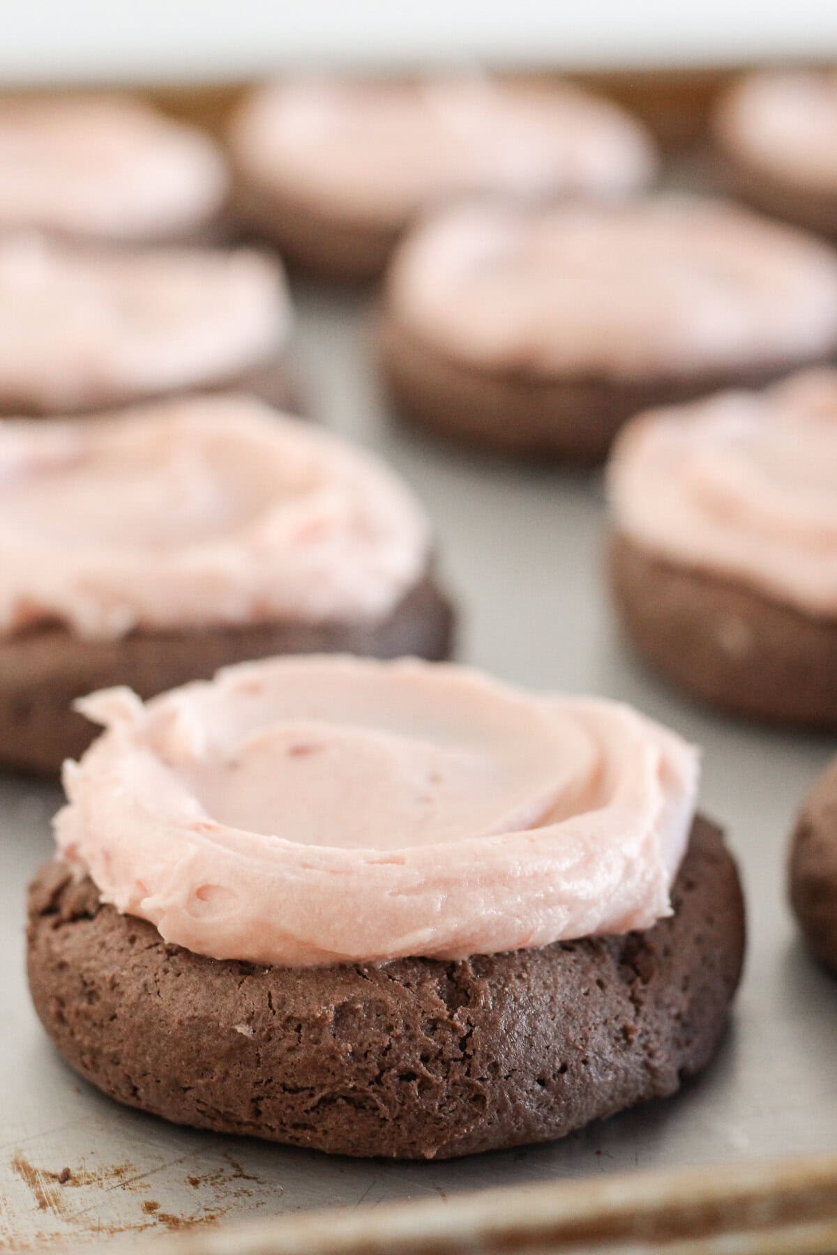 Strawberry buttercream added to a cake mix cookie.