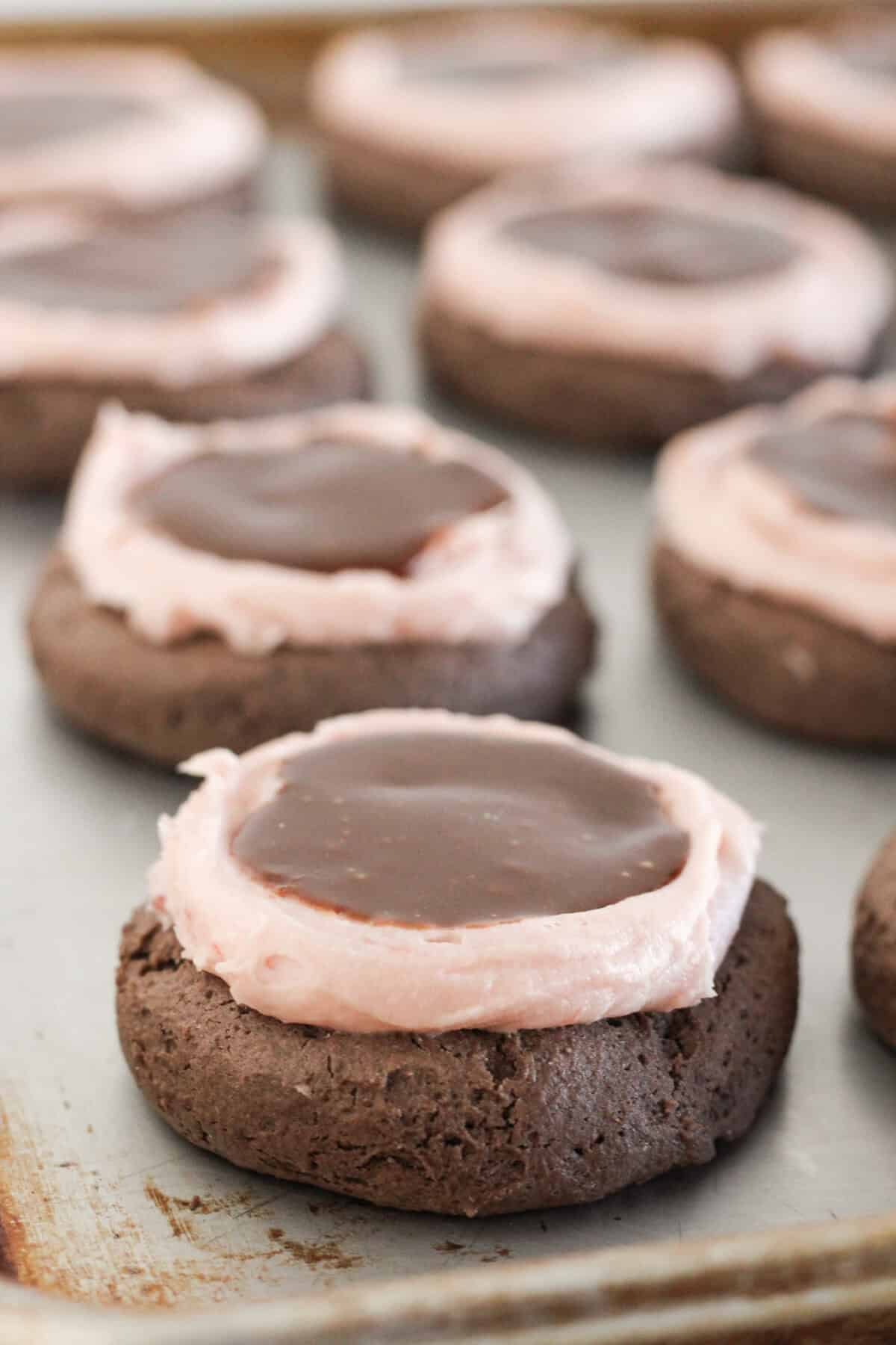 Chocolate ganache added to the top of each cookie.