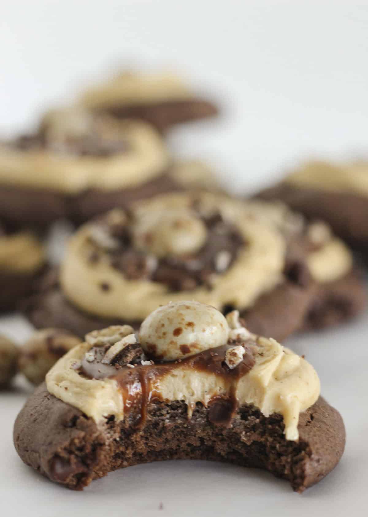 Chocolate espresso cookies on a tray with a bite taken from from one cookie.