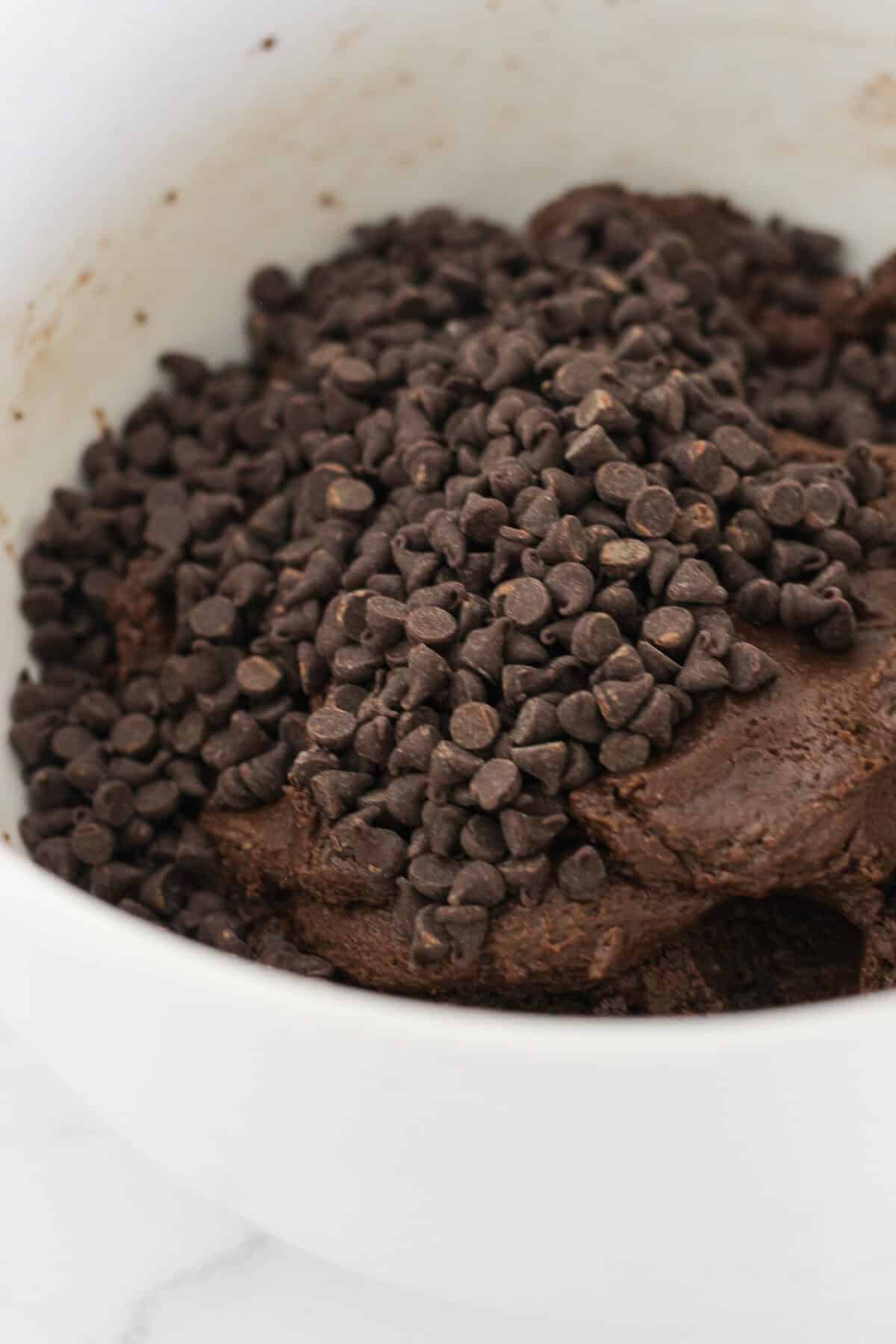 Adding mini chocolate chips to the chocolate espresso cookie dough.