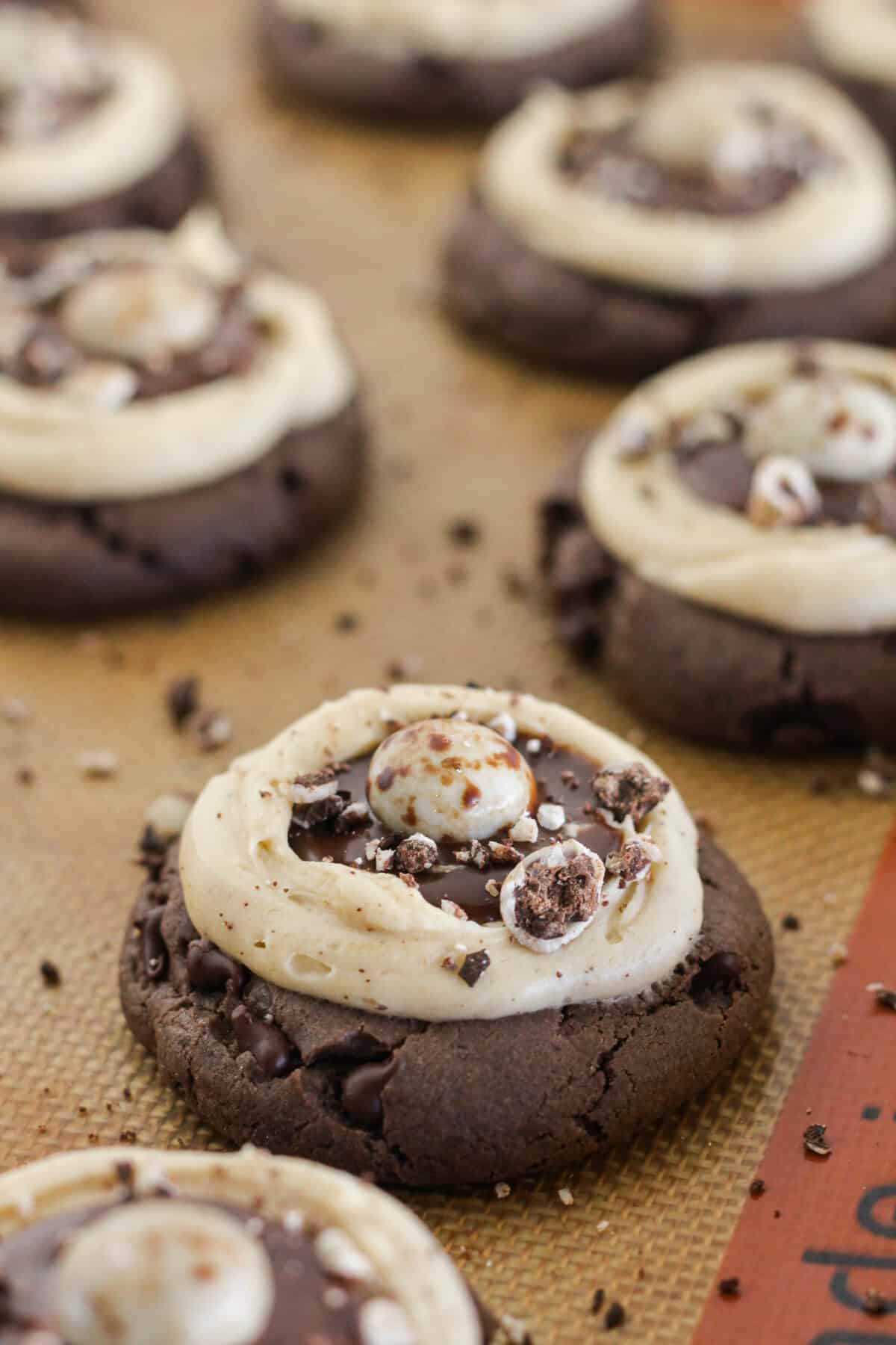 Frosted cookies with a chocolate covered espresso bean on top.