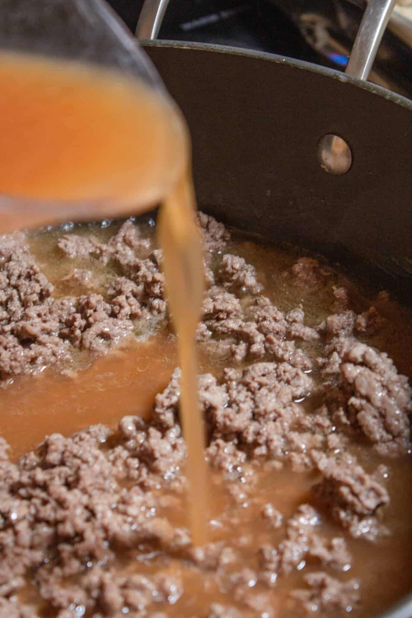 Browning the burger and adding the liquid in the skillet.