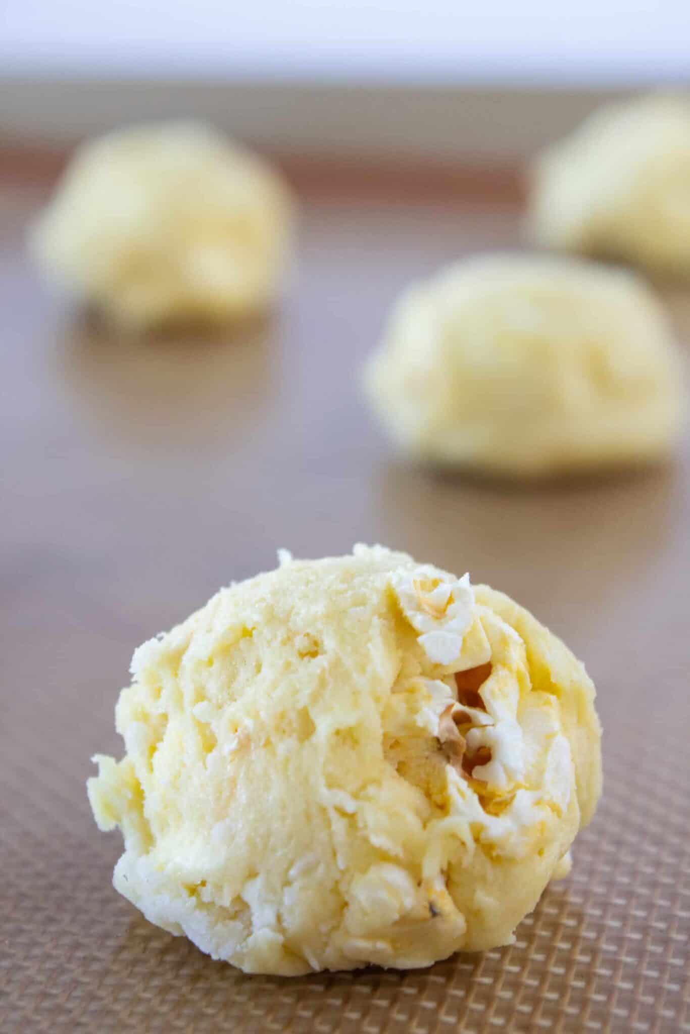 Adding the popcorn to the cookie dough and scooping the cookies.