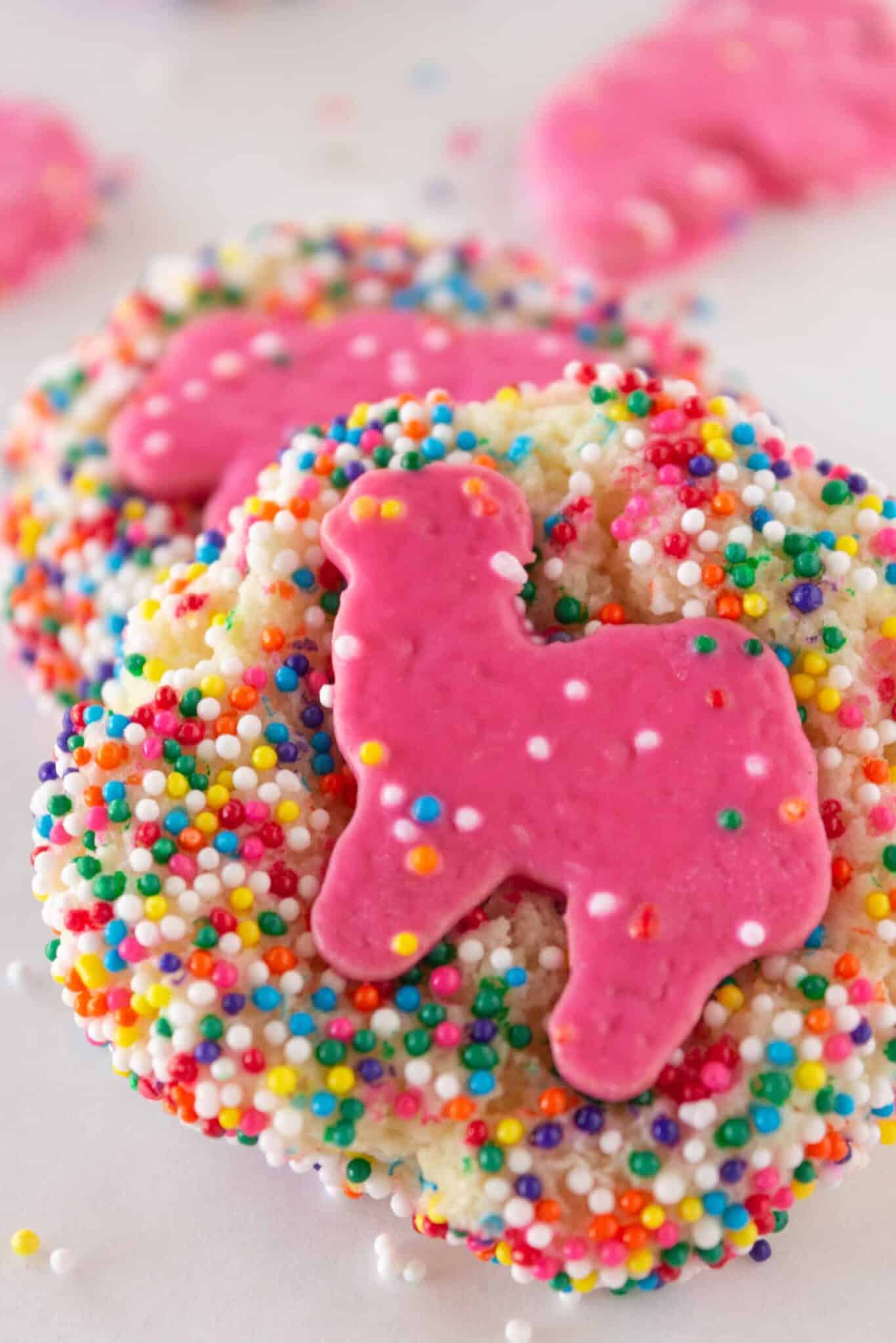 Frosted Animal Cookies with pink cookies on top.