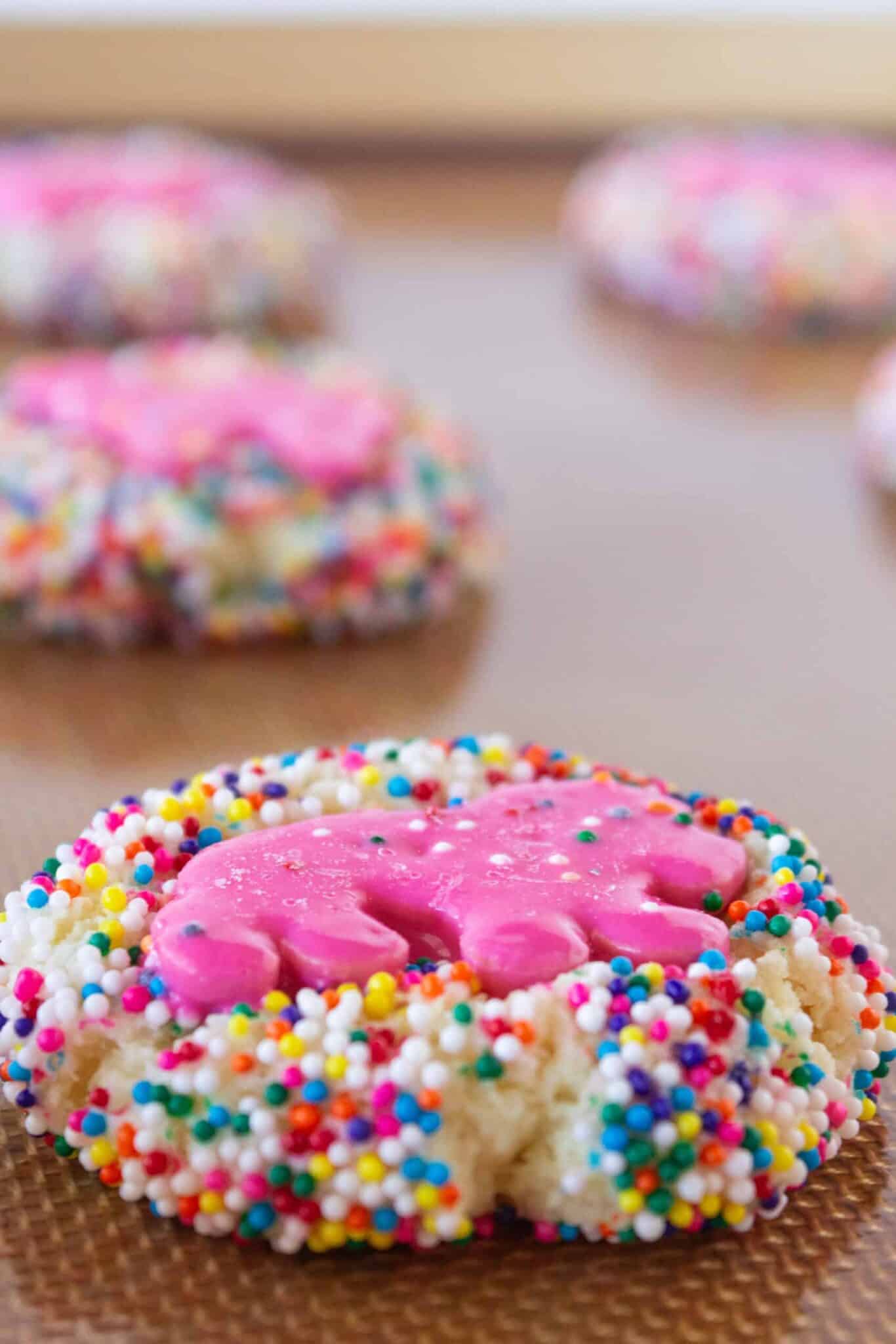 Baking the cookies and topping with a frosted animal cookie.