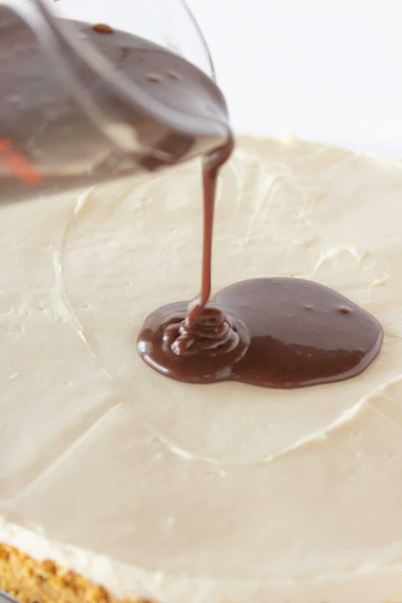 Finishing the S'mores cheesecake with chocolate ganache.