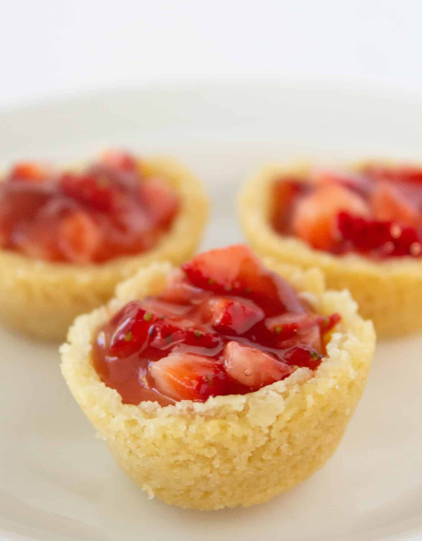 Three Strawberry Cream Cheese Pastry Bites on a plate.