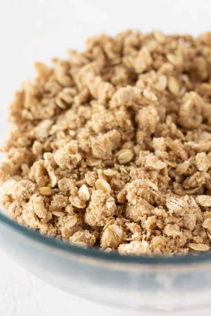 A crumble topping in a glass mixing bowl.