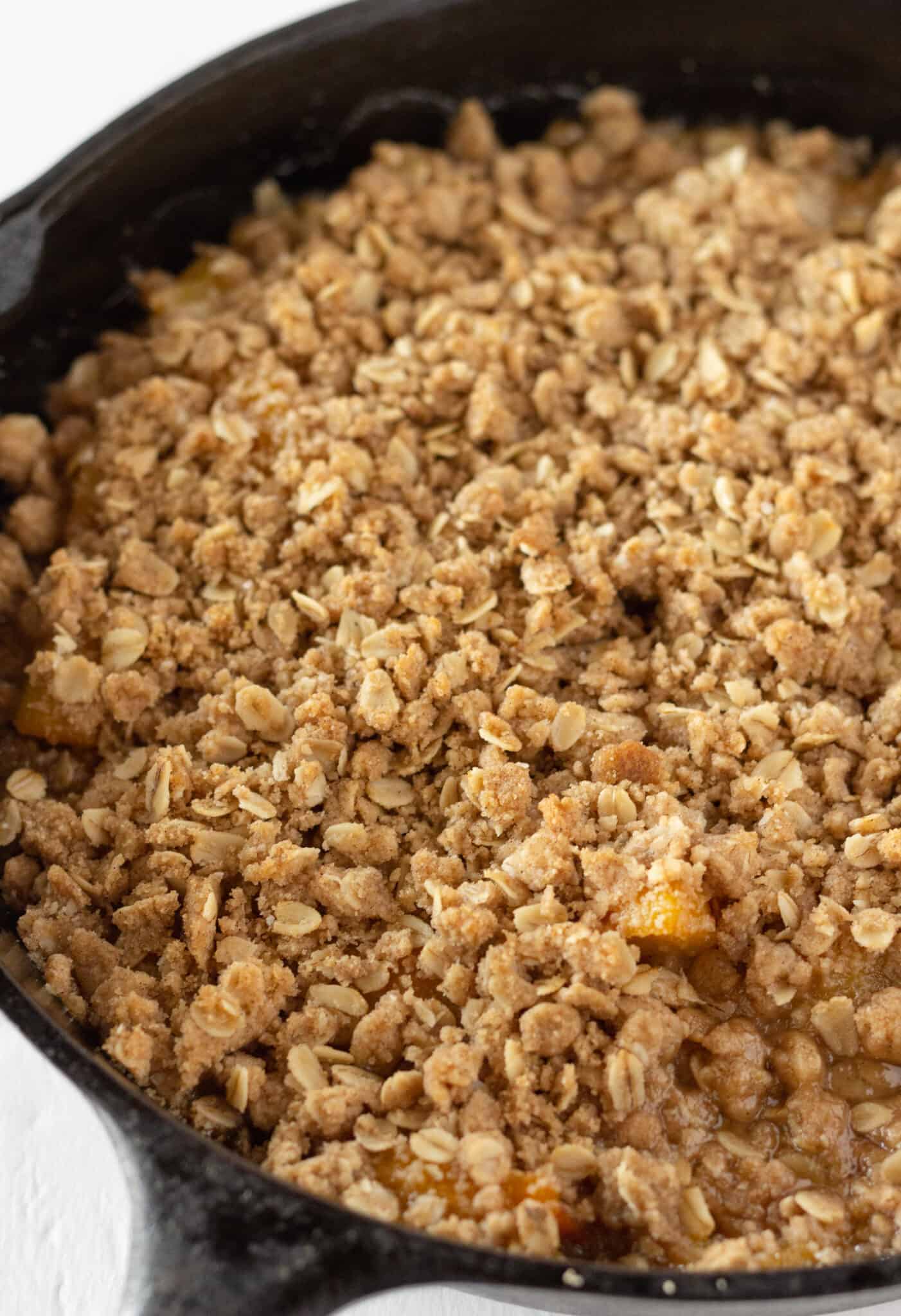 Easy Peach Crisp Recipe with Canned Peaches featured by top US dessert blogger, Practically Homemade