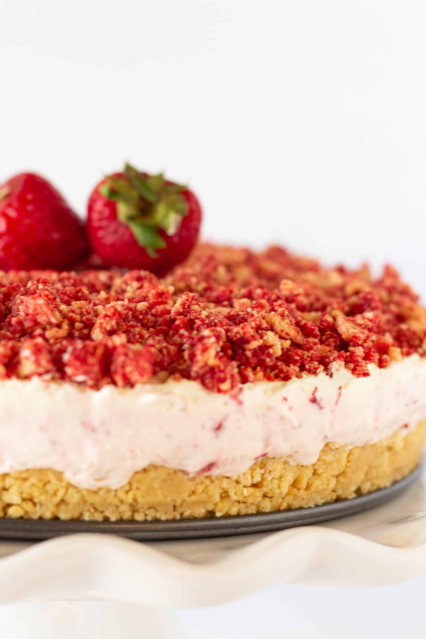 Strawberry Crunch Cheesecake recipe with a Golden Oreo Crust featured by top US dessert blogger, Practically Homemade