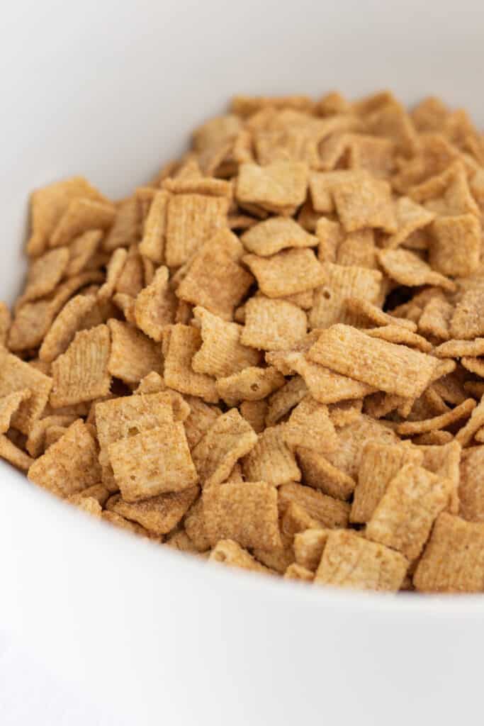 Cinnamon toast crunch cereal in a white mixing bowl.